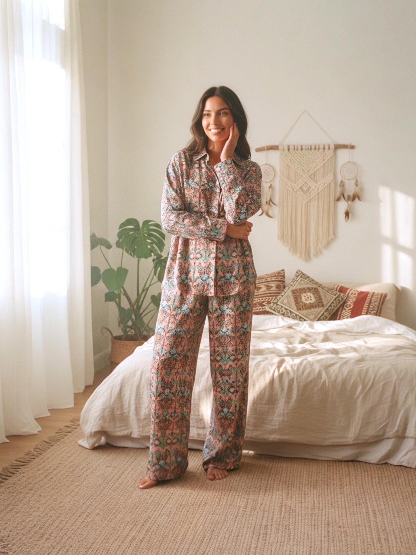 May include: A matching pajama set in a floral pattern. The set includes a button-down shirt and wide-leg pants. The color palette features shades of peach, teal, and green. The pajamas are made of a soft, lightweight fabric, perfect for lounging.