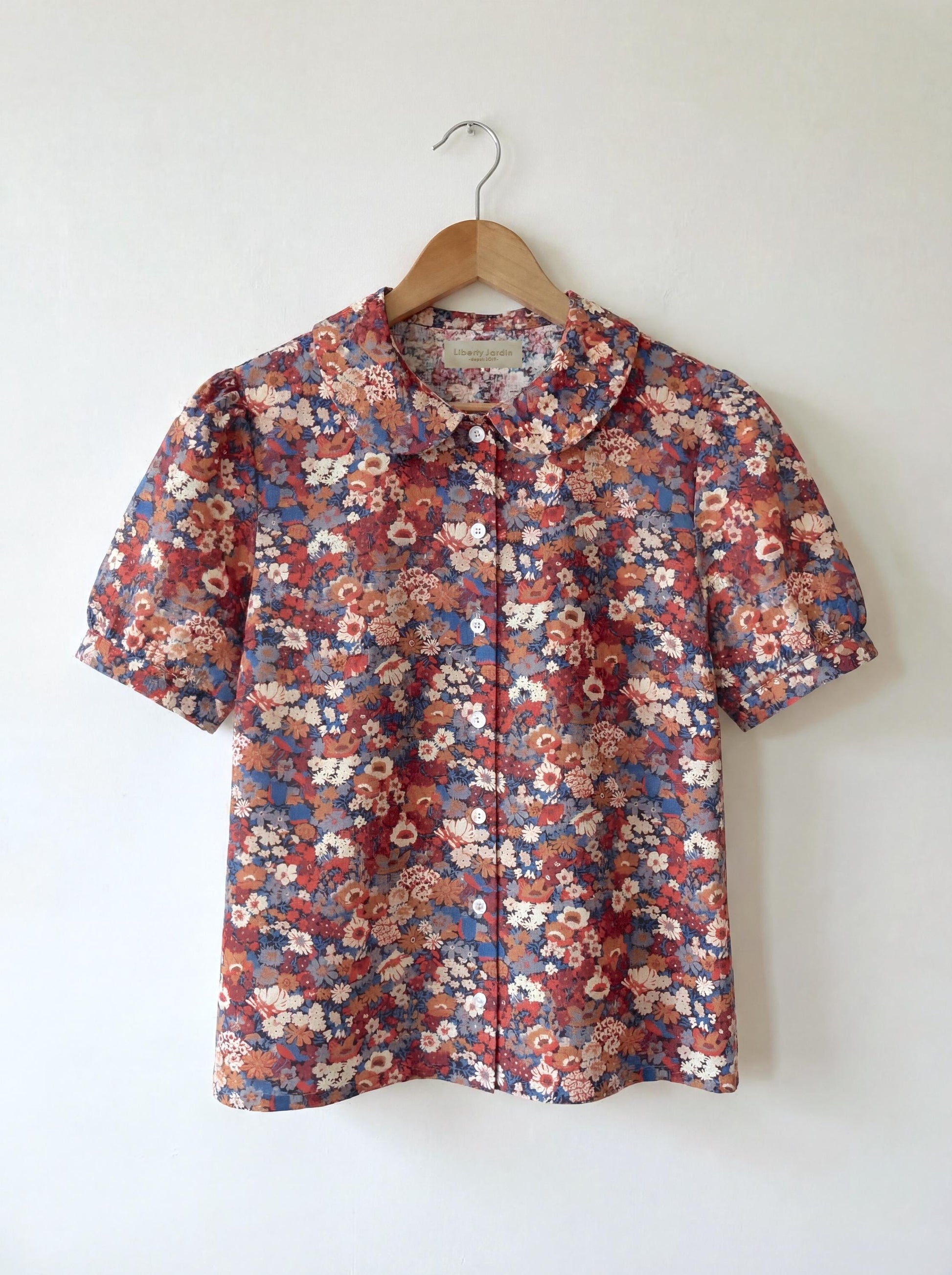 Sleeveless Liberty Woman Top: Ruffle Peter Pan Collar, Floral Print Blouse